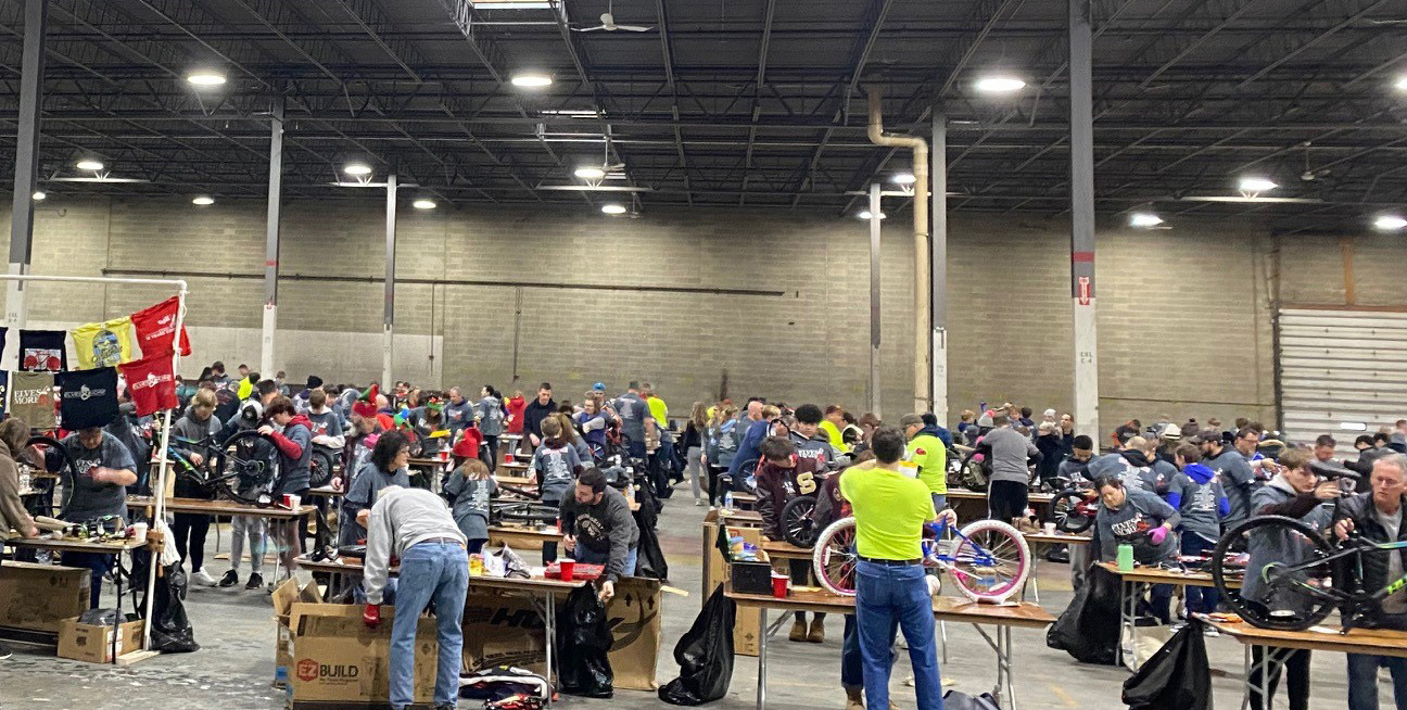 Elves & More volunteers assembling bikes at ASW Global