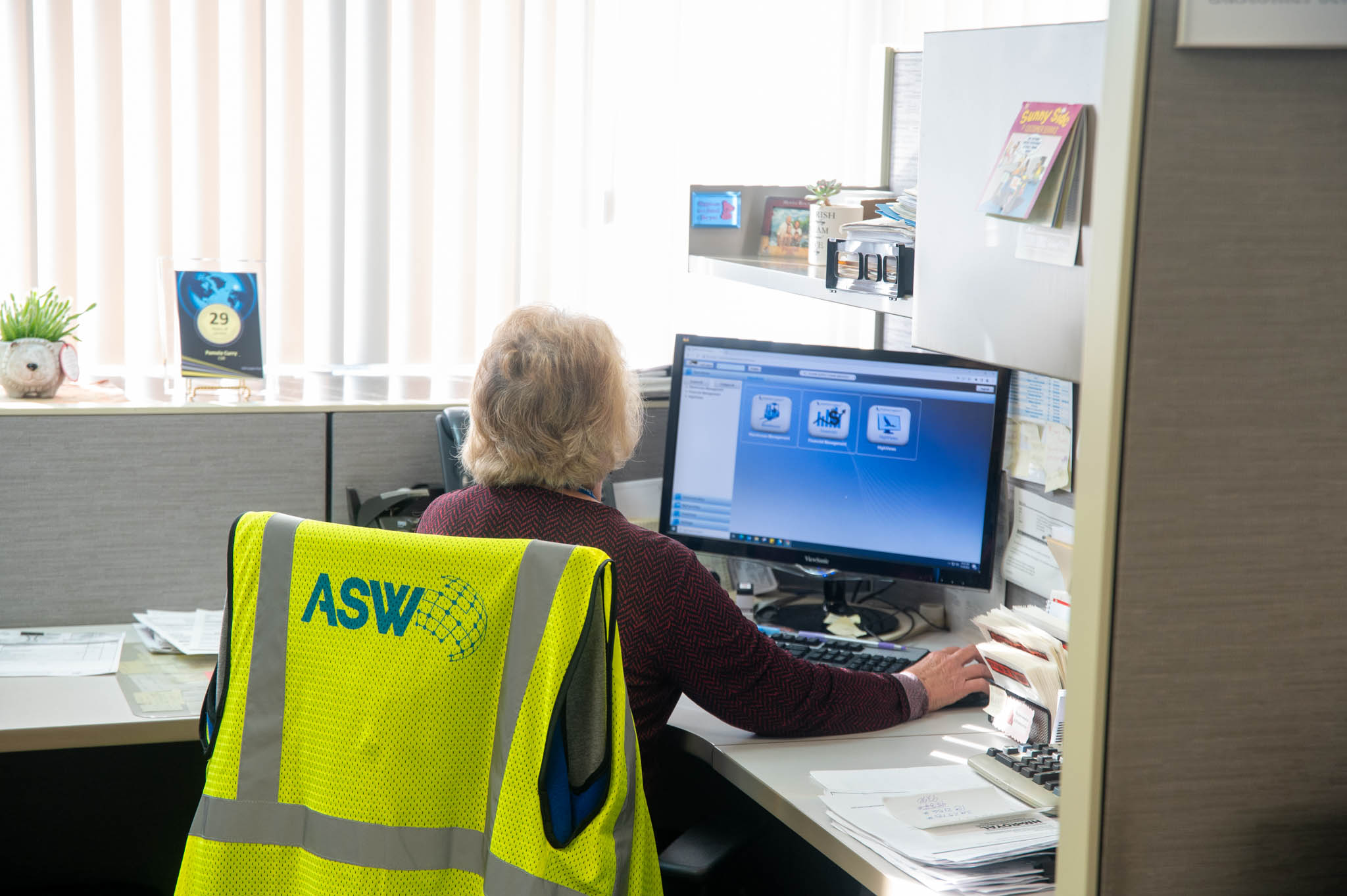 An ASW Global Customer Service Representative works on the computer.
