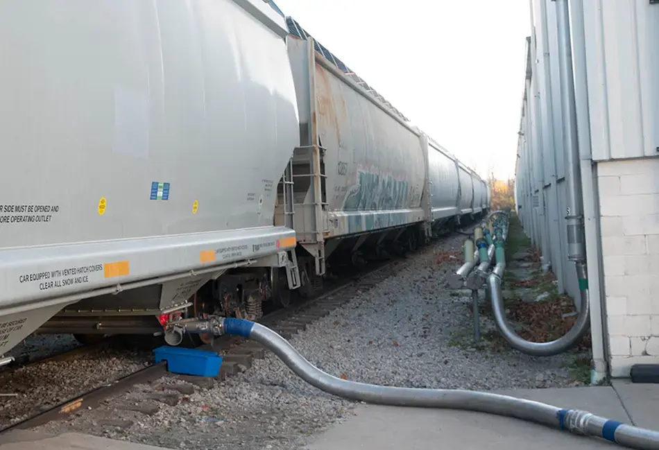 Polymer resin is being transloaded from this hopper car at ASW Global.ASW Global Team Track Hopper Cars