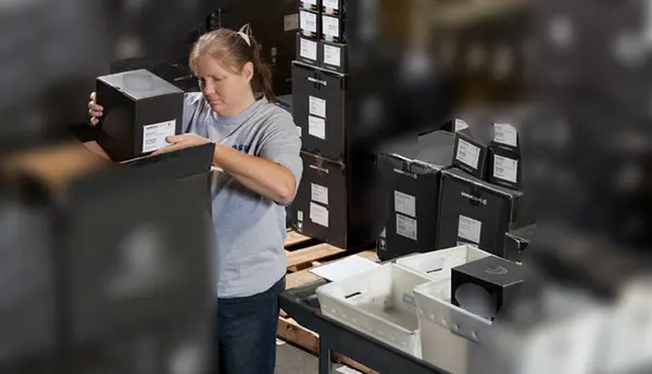 An associate fulfilling an industrial lights order at distribution center